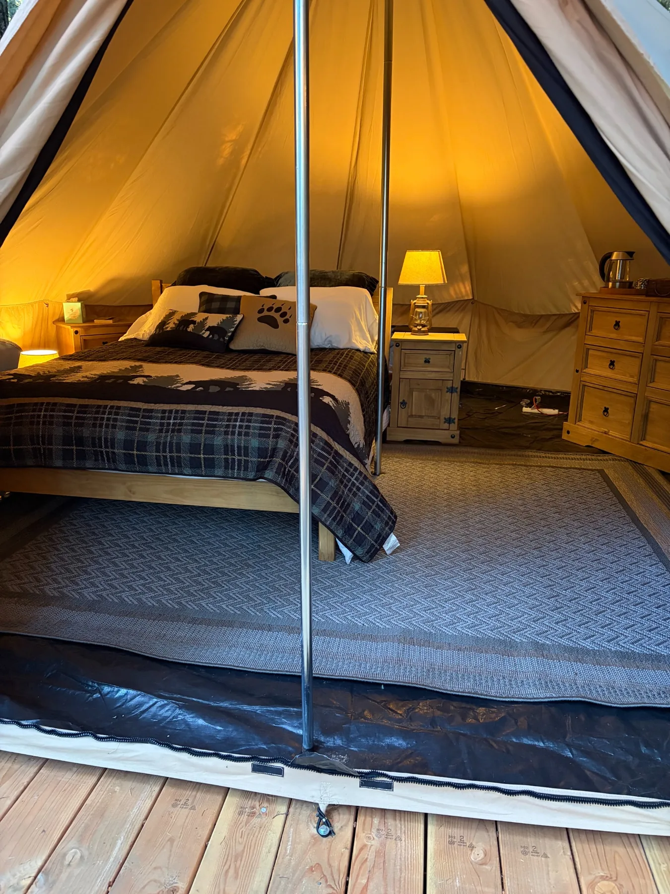 View from the tent entrance toward the queen bed and dresser