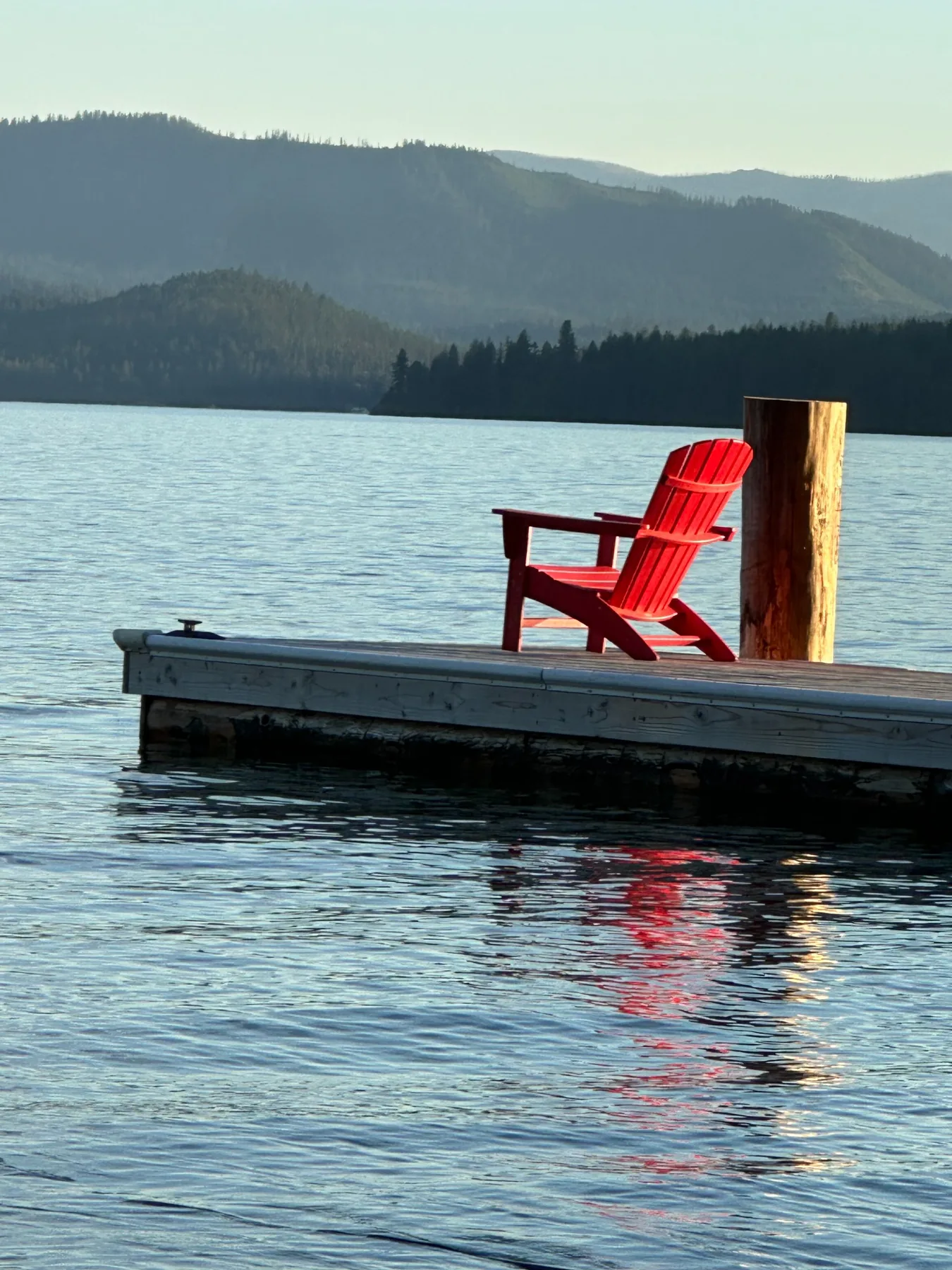 Red chair on the dock overlooking Priest Lake